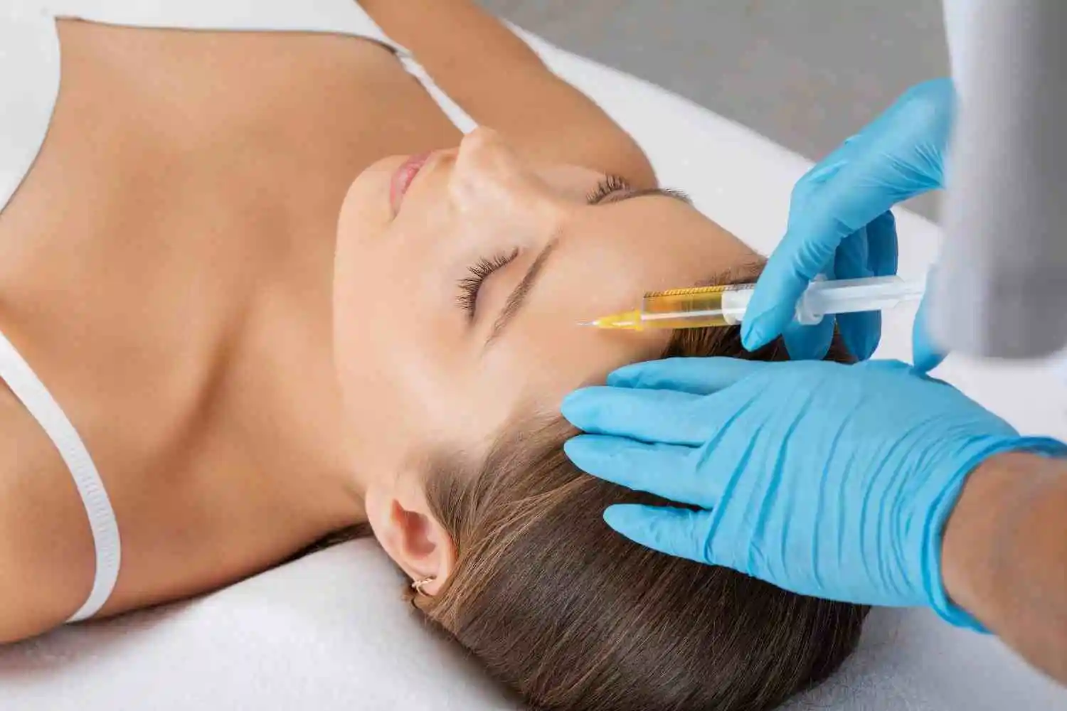 Woman receiving a PRP facial treatment from a skincare professional